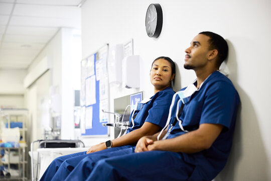 Doctor and Nurse Resting in Hospital Hallway