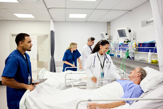 Doctor and Nurses Attending patients in Hospital Room