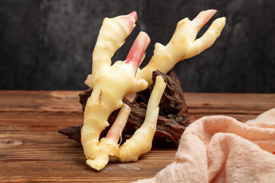 Fresh Ginger Root with Young Shoots on Rustic Wooden Table