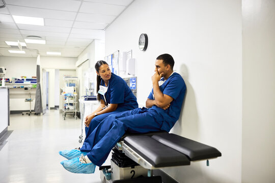 Doctors Chat in Hospital Hallway During Shift