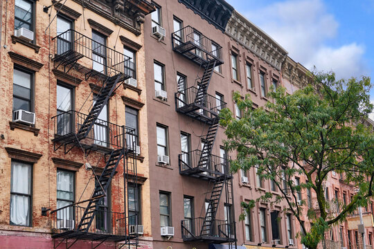 Manhattan, row of narrow old apartment buildings with external fire escape