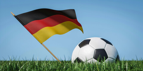 Naklejka premium Black Red and Yellow National Flag Waving Beside Soccer Ball on Green Grass Field