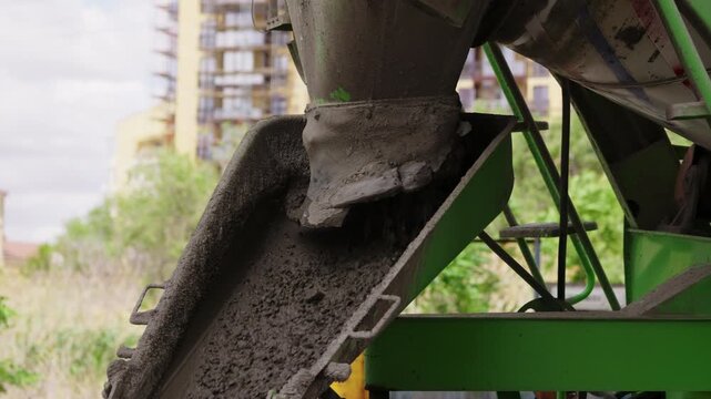 Concrete discharge from mixer truck chute at construction site