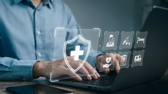 Man in blue shirt using laptop with health insurance icons and medical technology hologram