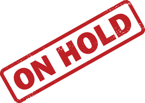 Striking red rubber stamp with phrase ON HOLD indicating a temporary pause or deferred action