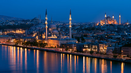 Obraz premium Istanbul skyline with historic mosques and illuminated buildings along the golden horn. Reflecting city lights on the water after sunset during twilight
