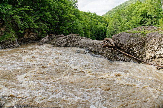 Fluvial erosion and mechanical weathering shaping ancient limestone rock formations during flash flood