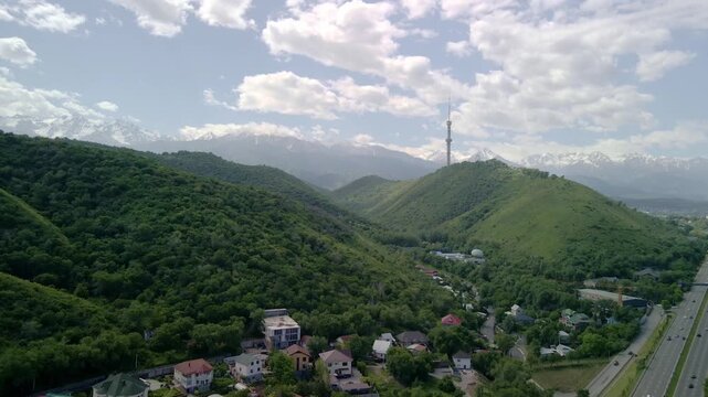 6.6.2026 Almaty.Kazakhstan. Aerial view of Kok Tobe hill with Almaty television tower and snowy mountains background, Kazakhstan