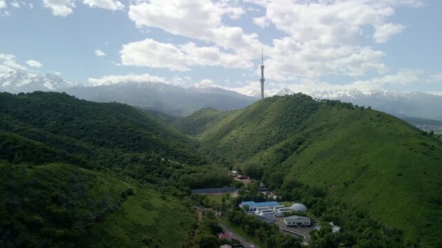 6.6.2026 Almaty.Kazakhstan. Aerial view of Kok Tobe hill with Almaty television tower and snowy mountains background, Kazakhstan