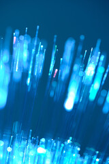 Vertical blue fiber optic lines macro shot with beautiful glowing bokeh dots. © freeman83