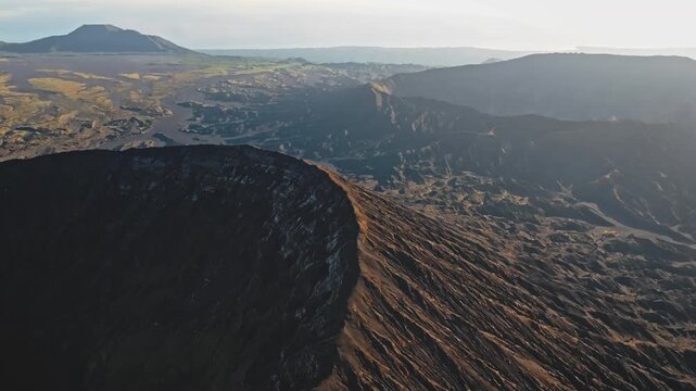 Ambrym Island's vast volcanic caldera with the dramatic Benbow and Marum craters seen from above, highlighting Vanuatu's raw, remote and active volcanic landscape. Drone flight panorama