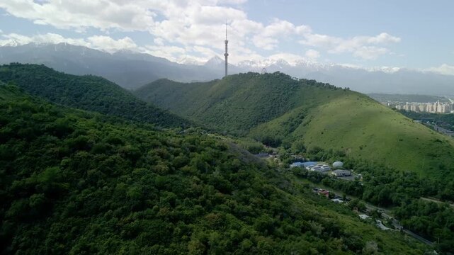 6.6.2026 Almaty.Kazakhstan. Aerial view of Kok Tobe hill with Almaty television tower and snowy mountains background, Kazakhstan