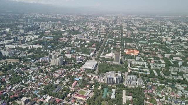 Stunning aerial view of Almaty city skyline with snowy mountain peaks, Kazakhstan