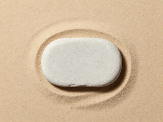 Obraz premium A serene white stone sitting on a bed of sand with circular patterns