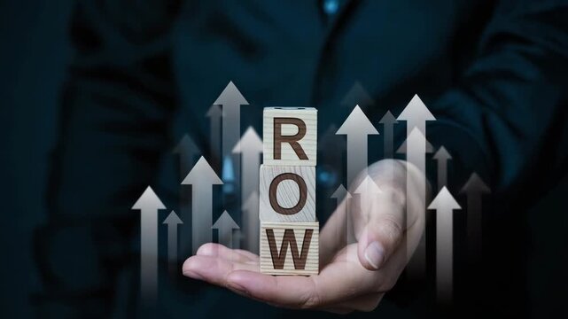 Businessman holding wooden blocks with grow text and arrows indicating growth and progress in business and finance