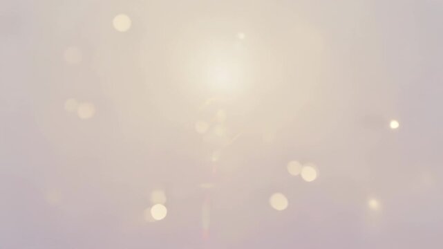 Appearing lights densifying bokeh cluster drifting across mauve gradient with faint vertical flare