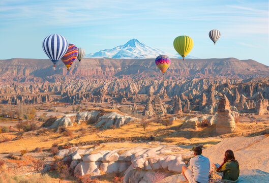 Hot air balloon flying over spectacular Cappadocia at sunset - Goreme, Turkey