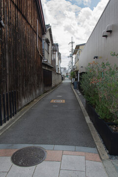 Narrow Japanese Alley Between Traditional Wooden and Modern Buildings
