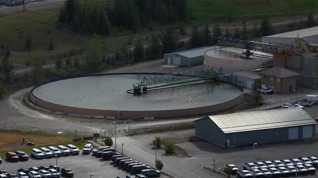 Aerial of industrial facility and large parking lot in Kellogg Idaho showing a massive water treatment plant complex
