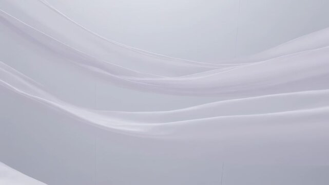 Animation starting sending sheer silk ribbons gliding across gray backdrop, showing fabric texture