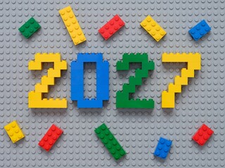 Naklejka premium Tambov, Russian Federation - October 13, 2024 Lego numbers 2027 with some Lego bricks on a gray baseplate background.