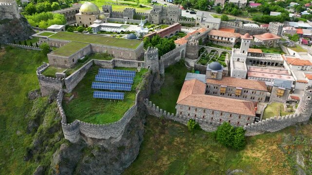 Aerial drone view of Rabati Castle in Akhaltsikhe, a historic fortress complex in southern Georgia featuring medieval architecture, defensive walls, towers and landscaped grounds.