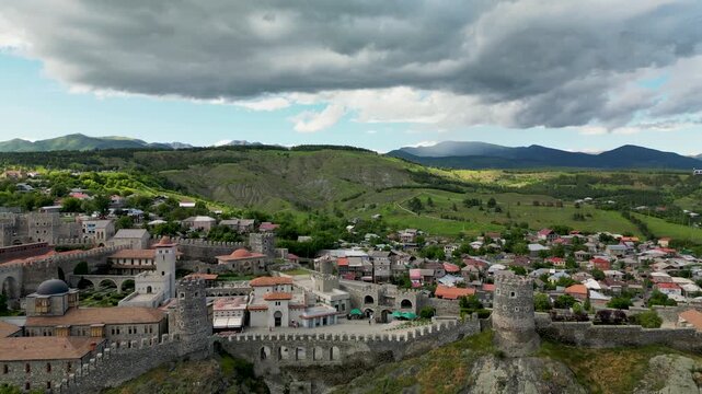 Aerial drone view of Rabati Castle and the surrounding city of Akhaltsikhe. Historic fortress complex with medieval architecture, towers, defensive walls and urban landscape in southern Georgia.