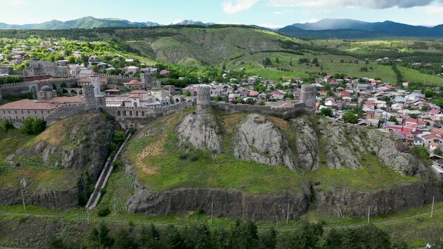 Aerial drone view of Rabati Castle and the surrounding city of Akhaltsikhe. Historic fortress complex with medieval architecture, towers, defensive walls and urban landscape in southern Georgia.