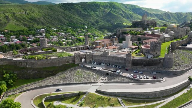 Aerial drone view of Rabati Castle in Akhaltsikhe, a historic fortress complex in southern Georgia featuring medieval architecture, defensive walls, towers and landscaped grounds.
