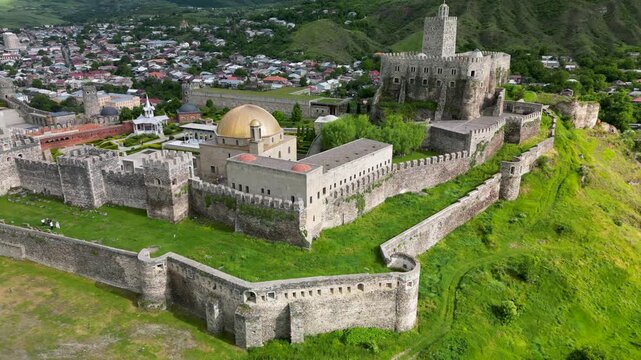 Aerial drone view of Rabati Castle in Akhaltsikhe, a historic fortress complex in southern Georgia featuring medieval architecture, defensive walls, towers and landscaped grounds.