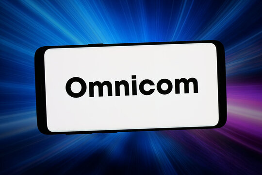 Stuttgart, Germany - 06-10-2026: In this photo illustration, the logo of US marketing company Omnicom Group Inc. (OMC) is displayed on a smartphone in front of abstract background on computer screen.