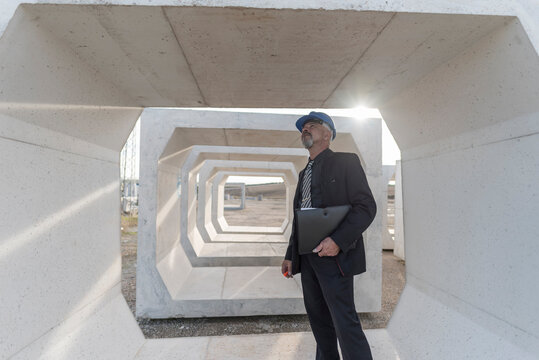 Industrial inspector checks the quality of the concrete structures and frames used for the construction of bridges and aqueducts