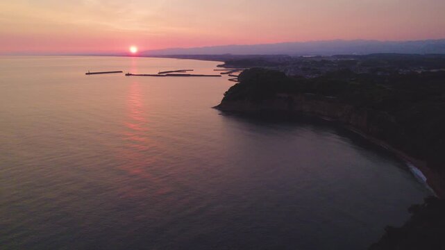 石川県 加佐ノ岬の日の出 左後方へ移動しながら灯台を捉えるドローン空撮 Sunrise at Cape Kasano, Ishikawa, Drone Moving Backward-Left Revealing Lighthouse