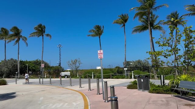 Tropical Beach entrance, drop off zone with security cameras and metal bollards