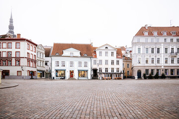 Fototapeta premium Historic buildings and cobblestone pavement in Town Hall Square, Tallinn
