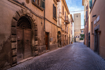 Naklejka premium Picturesque medieval alley with historic tower in Tarquinia, Italy.