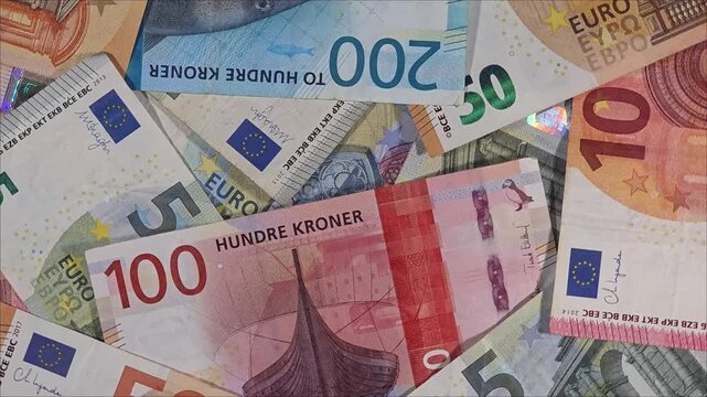 Nordic exchange rate with euro and norwegian banknotes, rotating background view