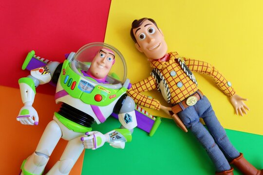 Salvador, Brazil - June 15, 2026: Sheriff Woody and Buzz Lightyear toys on a colorful background. Toy Story movie concept.