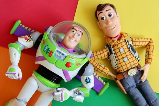 Salvador, Brazil - June 15, 2026: Sheriff Woody and Buzz Lightyear toys on a colorful background. Toy Story movie concept.
