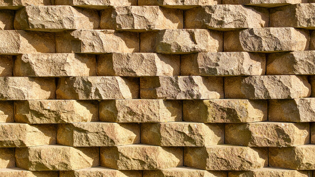 Aligned geometric stone retaining wall background texture
