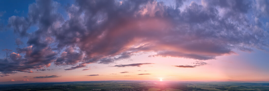 Panoramic Aerial Sunset Sky with Dramatic Clouds and Clean Copy Space Background. Open horizon and no distracting elements.