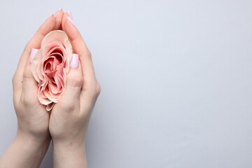Naklejka premium Gynecology. Woman with beautiful rose on grey background, top view. Space for text