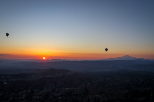 Hot Air Balloons at Sunrise Over Cappadocia Landscape