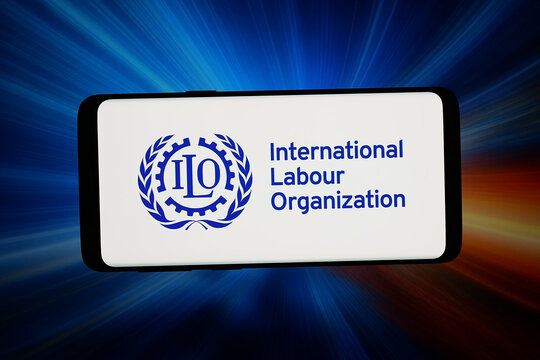 Stuttgart, Germany - 06-10-2026: In this photo illustration, the logo of International Labour Organization (ILO) is displayed on a smartphone in front of abstract background on computer screen.