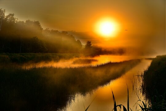 Beautiful golden sunrise over a maisty river in the morining