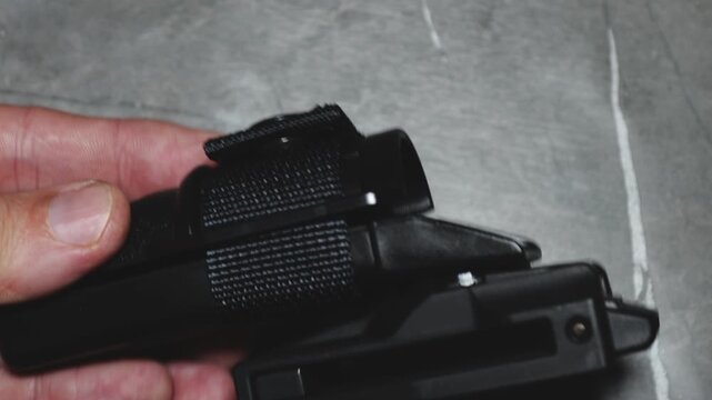 hand holding a holder for a baton for self-defense
