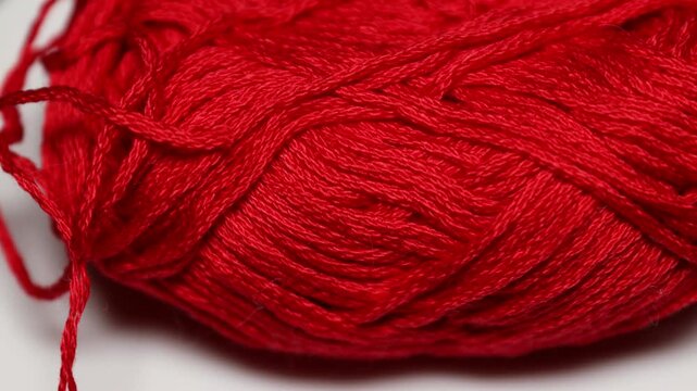 A single red ball of yarn on a clean white background, perfect for showcasing yarn or creating a simple design