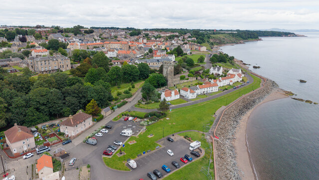 Aerial panoramic view of Dysart coastline with St Serf's Tower, traditional Scottish houses, and the Firth of Forth coast in Fife, Scotland