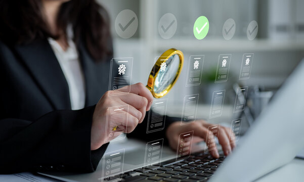 A business professional inspects digital documents using a magnifying glass, highlighting attention to detail and quality control in a modern office setting. Cyphers