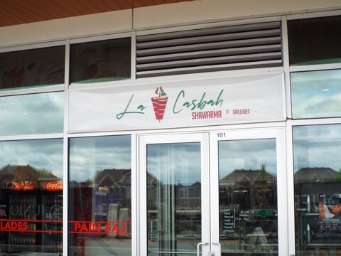 Gatineau, Quebec, Canada &ndash; May 12, 2026: Two side-by-side sidewalk signs promote "La Casbah" restaurant, featuring menu photos, delivery service logos, and an open sign on All&eacute;e de Hambourg.